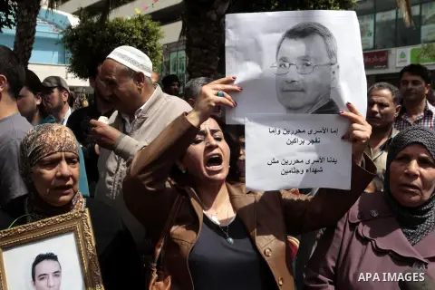 Palestinians take part a protest in the West Bank city of Nablus, 02 April 2013, after the news of the death of Maysara Abu Hamdiyeh in the Israeli Soroka hospital. Reports state that Maysara Abu Hamdiyeh died after bein...