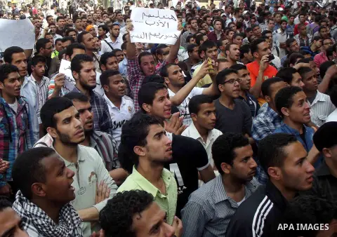 Egyptian students from the al-Azhar University take part in a protest in Cairo on April 3, 2013, after hundreds suffered food poisoning at a dormitory. Students stormed the gates of the Cairo headquarters of Egypt's Isla...