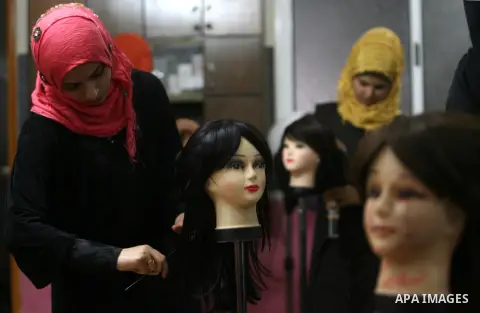 Palestinian girls attend lesson of the hairdressing beauty at The Adam Training Academy, in Rafah town in the southern Gaza Strip on Apr. 06, 2013. Photo by Eyad Al Baba