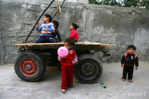 Palestinian children play outside their home in the Rafah refugee camp in the southern Gaza Strip on April 6, 2013. Gaza's Hamas rulers urged the United Nations to reconsider its suspension of food aid for Palestinian re...