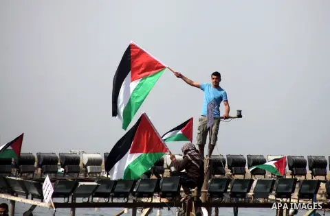 Palestinian fishermen riding fishing boats take part in a protest calling for an increased fishing zone, at the seaport of Gaza City April 7, 2013. Israel suspended part of a Cairo-brokered truce agreement by halving Pal...