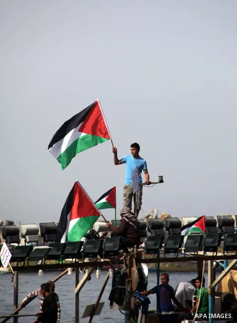 Palestinian fishermen riding fishing boats take part in a protest calling for an increased fishing zone, at the seaport of Gaza City April 7, 2013. Israel suspended part of a Cairo-brokered truce agreement by halving Pal...