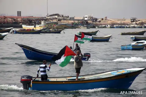Palestinian fishermen riding fishing boats take part in a protest calling for an increased fishing zone, at the seaport of Gaza City April 7, 2013. Israel suspended part of a Cairo-brokered truce agreement by halving Pal...