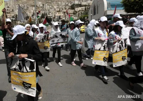 Palestinian children hold placards during a rally marking Palestinian children's day, in the West Bank city of Nablus on April, 07, 2012. Photo by Nedal Eshtayah