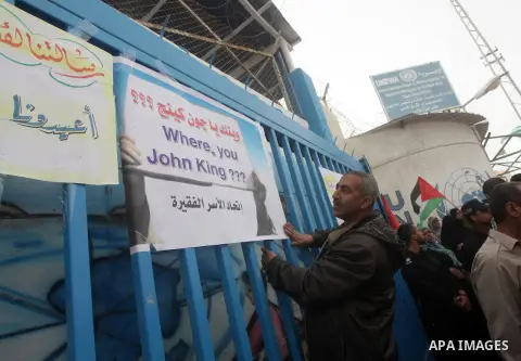 Palestinians take part in a protest against the reduction of some of the financial and food aid services given by the United Nations Relief and Works Agency (UNRWA) to Palestine refugees, in Gaza city on April 8, 2013. P...