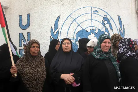 Palestinians take part in a protest against the reduction of some of the financial and food aid services given by the United Nations Relief and Works Agency (UNRWA) to Palestine refugees, in Gaza city on April 8, 2013. P...