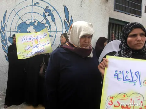 Palestinians take part in a protest against the reduction of some of the financial and food aid services given by the United Nations Relief and Works Agency (UNRWA) to Palestine refugees, in Gaza city on April 8, 2013. P...