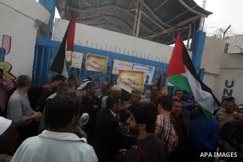 Palestinians take part in a protest against the reduction of some of the financial and food aid services given by the United Nations Relief and Works Agency (UNRWA) to Palestine refugees, in Gaza city on April 8, 2013. P...