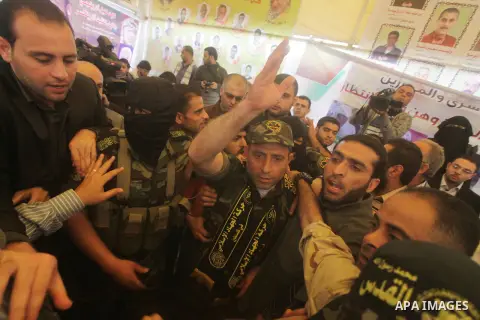 Ebrahim Barod, celebrates with fellow Palestinian militants, following his release from an Israeli jail after being detained for 27 years, as he arrives home to the Jabalyia refugee camp, in the northern Gaza Strip, on A...