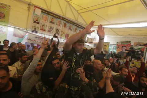 Ebrahim Barod, celebrates with fellow Palestinian militants, following his release from an Israeli jail after being detained for 27 years, as he arrives home to the Jabalyia refugee camp, in the northern Gaza Strip, on A...