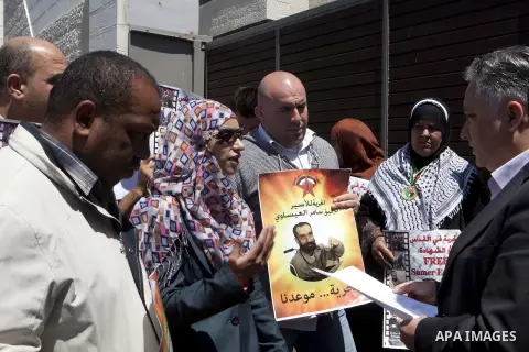 Palestinian protesters deliver a message to the head of foreign relations and media of the Quartet representative Office in Sheikh Jarrah, during a demonstration demand for release of Samer al-Issawi, a Palestinian priso...
