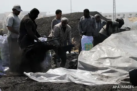Palestinian workers fill bags with coal to be sold, at one of the few local charcoal manufacturing shops east of Gaza City on April 16, 2013. In adapting to years of border blockades and shortages, Gazans have become exp...