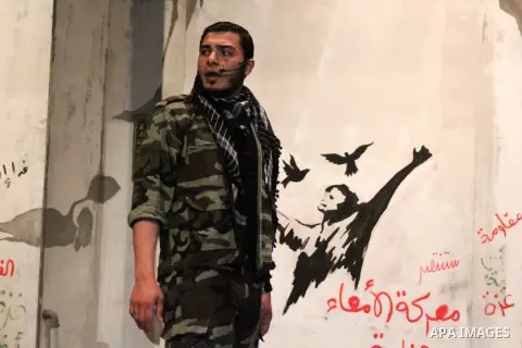 A Palestinian artist performs during a ceremony organized by Islamic Jihad movement, to show solidarity with Palestinian prisoners inside Israeli jails, ahead of Palestinian prisoner's day in Gaza city on April 16, 2013....