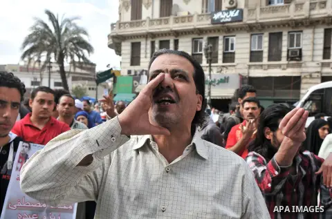 Members of the 6th of April movement and relatives of protester killed during the 2011 Egyptian revolution shout anti-government slogans and demand the release of political prisoners during a demonstration outside the Eg...