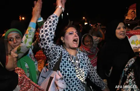 Egyptian supporters of former President Hosni Mubarak hold his pictures during a demonstration outside the Maadi military hospital demanding authorities to keep him in the hospital, near Cairo, on April 17, 2013. Egyptia...