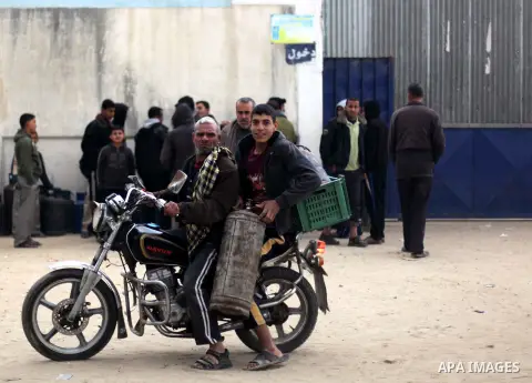 Palestinians wait near of the empty gas canisters at a natural gas station at Deir al-Balah in central Gaza Strip on April 22, 2013. The Gaza Strip has been facing a gas crisis for the past two months partially due to th...