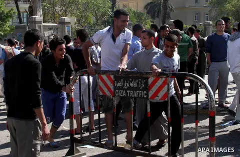 Egyptian students of Cairo University block the road in front of student dormitory during a protest against dormitory management, in Cairo on April 26, 2013. Photo by Tareq Gabas