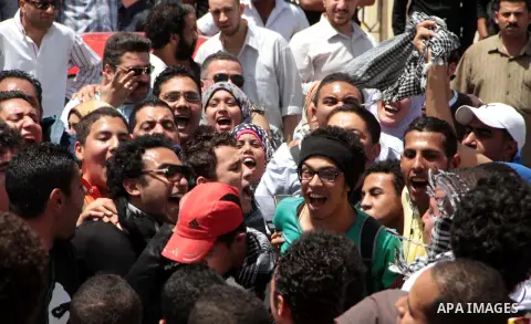 Egyptian members of 6th April movement celebrate the releasing of four members of the movement in front of Attorney General's Office in Cairo on April 29, 2013. Three of the group's members and one other protester have b...