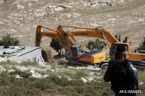 Israeli security forces stand guard as Jerusalem municipality workers use bulldozers to demolish a Palestinian home owned by Ghaith family in the mostly Arab east Jerusalem neighbourhood of al-Tur on April 29, 2013. Pale...
