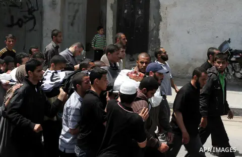 Palestinian mourners carry the body of Haitham Al-Mes-hal, who relatives said belonged to a militant Jihadist Salafi organisation, during his funeral in Gaza City April 30, 2013. Israel on Tuesday launched its first targ...