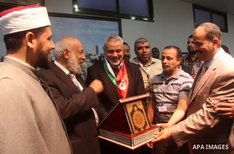Palestinian Prime Minister in Gaza strip Ismail Haniyeh meets with members of "al-Wafaa convoy" which includes activists from Turkey, Tunisia, Egypt and Europe, in Gaza city on May 02, 2013. Haniyeh emphatically rejected...