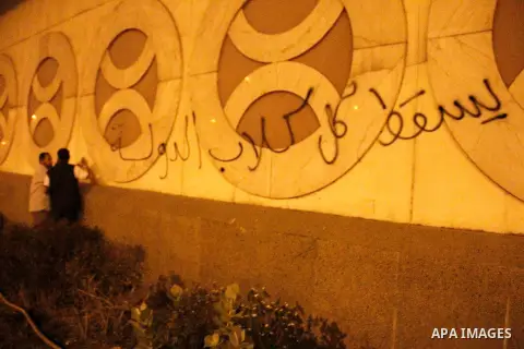 Egyptian Islamists write slogans on the wall of the Egyptian National Security Building during a protest on May 3, 2013 in Cairo, Egypt. Hundreds of Salafist Islamists protested outside the Egyptian National Security Age...
