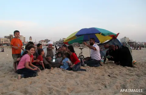 Palestinians enjoy swimming in the sea at Gaza beach during Friday holiday in Gaza city, May 03, 2013. Gazans escape to the beach and out from their homes during heat wave and power outages. Photo by Ezz al-Zanoon