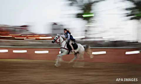 A Palestinian girl rides a horse during a training session at the Equestrian Club in the west of the Jabaliya refugee camp in the northern Gaza strip, May 05 2013. Palestinian families go to tourist sites and entertainme...