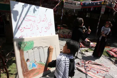 Palestinian children participate in a theatrical performance to mark the 65th anniversary of the 'Nakba' (catastrophe) at the Islamic University in Gaza City on May 6. 2013. As Israel celebrates its 65th anniversary, Pal...