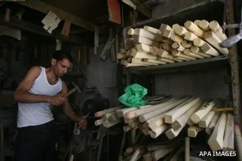 A Palestinian laborer works at a carpentry workshop in Rafah in southern Gaza strip, on May 06, 2013. Photo by Eyad Al Baba