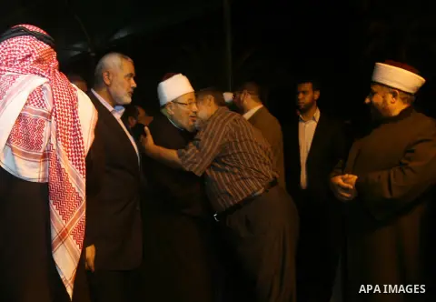 Cleric and chairman of the International Union of Muslim Scholars Sheikh Yusuf al-Qaradawi is welcome upon his arrival at Rafah Crossing in the southern Gaza Strip May 8, 2013. Al-Qaradawi arrived on Wednesday for a thre...