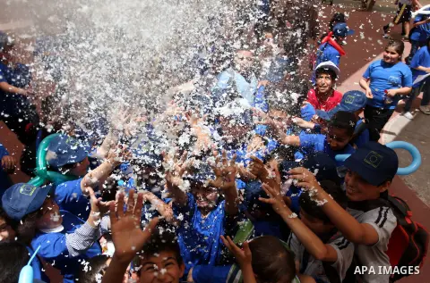 Palestinian children take part in a celebration to mark "Europe Day" in the West Bank city of Ramallah on May 9, 2013. Europe Day, also known as Schuman Day, is an annual celebration of peace and unity in Europe and comm...