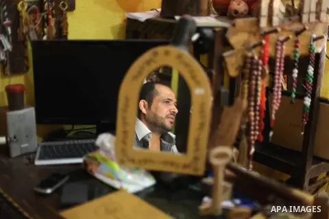 A Palestinian man works on wood keys at his souvenir shop in Gaza City on May 14, 2013. Palestinians will mark ''Nakba'' (Catastrophe) on May 15 to commemorate the expulsion or fleeing of some 700, 000 Palestinians from...
