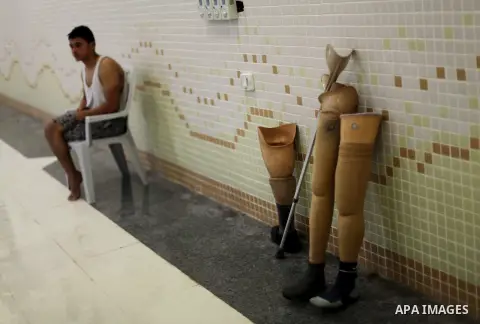 The prosthetic legs and crutch of wounded Palestinians taking part in swimming lessons are pictured inside al-Sadaka Club in Gaza City May 16, 2013. The swimming training sessions are organized by the Merciful Hands Soci...