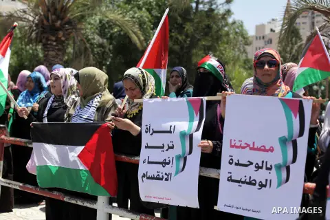 Palestinian women hold banners during a protest against split between Palestinian factions in Gaza city on May 21, 2013. The splitting started on 2006, after Hamas Islamic Movement had won in the legislative elections. P...
