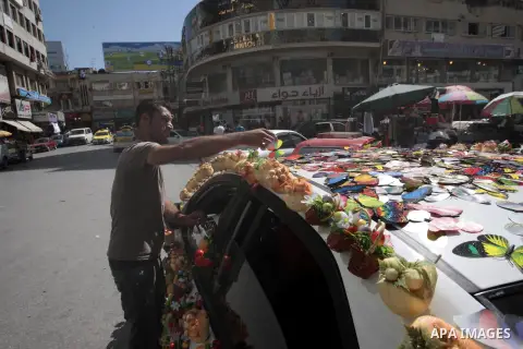 A Palestinian man display magnetic decorations on his car to sell it, at the main market of the West Bank city of Nablus, on May 22, 2013. Photo by Nedal Eshtayah