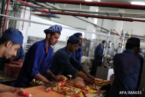 Palestinian employees work at al- Awda ice cream factory in Gaza city, on May, 23, 2013. Photo by Ashraf Amra