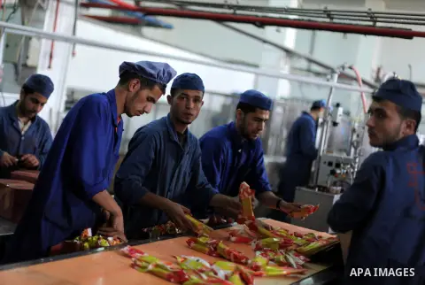 Palestinian employees work at al- Awda ice cream factory in Gaza city, on May, 23, 2013. Photo by Ashraf Amra