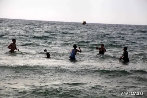 Palestinians enjoy swimming in the sea at Gaza beach during Friday holiday in Gaza city, May 24, 2013. Gazans escape to the beach and out from their homes during heat wave and power outages. Photo by Ashraf Amra