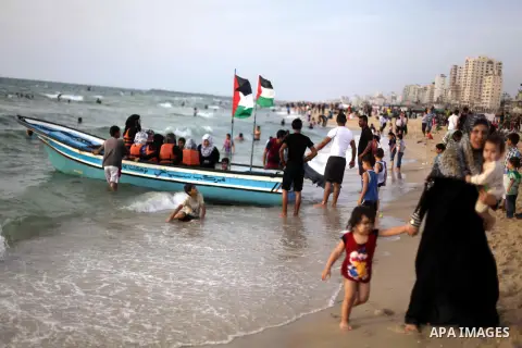 Palestinians enjoy swimming in the sea at Gaza beach during Friday holiday in Gaza city, May 24, 2013. Gazans escape to the beach and out from their homes during heat wave and power outages. Photo by Ashraf Amra