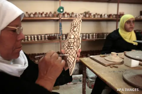 Palestinian woman makes antiques of ceramics and mosaics at the village of Sabastiya in the West Bank of Nablus city on May 27, 2013. The family is the only one still doing this work in Nablus City, they have a shop and...