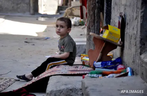 Palestinian children play outside their house in al Shatea refugee camp in the west of Gaza city on, 27 May 2013. The children enjoy their summer holiday after they finished final exams. Photo by Mohammed Talatene