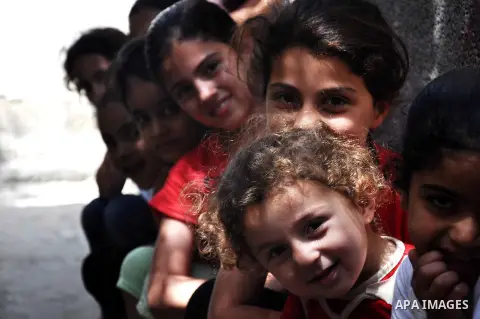 Palestinian children play outside their house in al Shatea refugee camp in the west of Gaza city on, 27 May 2013. The children enjoy their summer holiday after they finished final exams. Photo by Mohammed Talatene