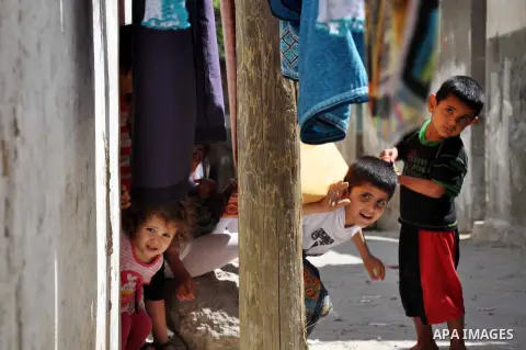 Palestinian children play outside their house in al Shatea refugee camp in the west of Gaza city on, 27 May 2013. The children enjoy their summer holiday after they finished final exams. Photo by Mohammed Talatene
