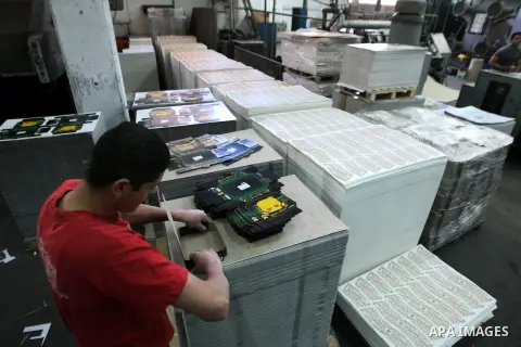 A Palestinian worker cuts the cardboard at the al-Ahlia carton factory, in the West Bank city of Hebron on May 27, 2013. Al-Ahlia Carton is one of the leading carton packaging companies. It offer packaging solutions to a...