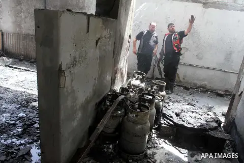 Palestinian firemen try to extinguish fire in a building western Gaza city on June 02, 2013. The fire sparked by unknown reason in a fuel tank using for an electric generator under the building, witnesses said. Photo by...