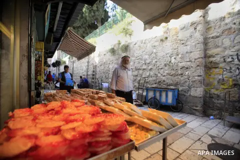 A Palestinian vendor sells traditional sweets during preperation to celebrate the Islamic holiday of Isra Mi'raj in the Jerusalem old city, on June 04, 2013. The holiday marks what Muslims believe is Prophet Mohammad's j...