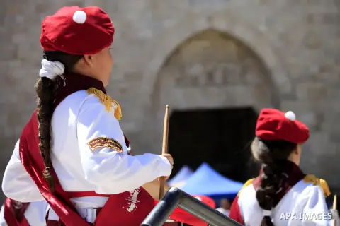 Palestinian scouts play musical instruments as they parade through the streets during a celebrate the Islamic holiday of Isra Mi'raj in the Jerusalem old city, on June 06, 2013. The holiday marks what Muslims believe is...