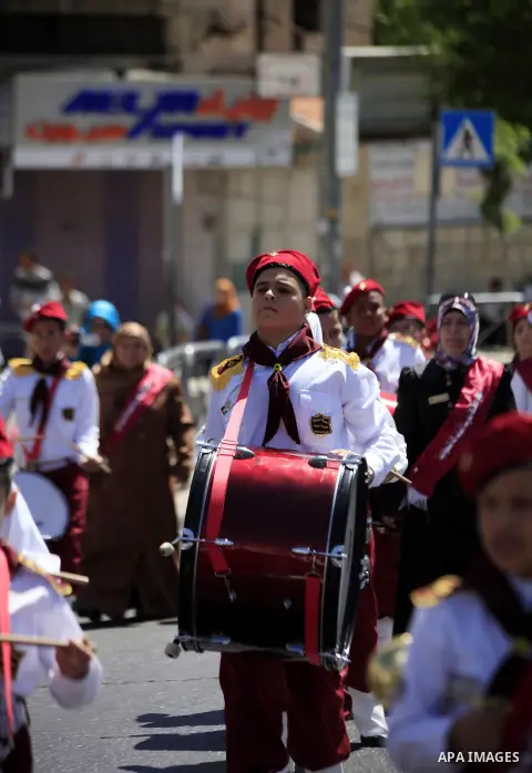 Palestinian scouts play musical instruments as they parade through the streets during a celebrate the Islamic holiday of Isra Mi'raj in the Jerusalem old city, on June 06, 2013. The holiday marks what Muslims believe is...