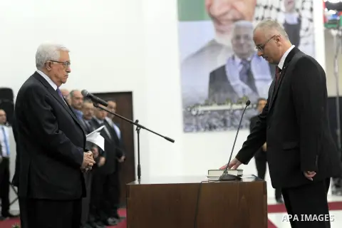 Palestinian Prime Minister Rami Hamdallah swears in during the oath ceremony in the West Bank city of Ramallah, 06 June 2013. Hamdallah and 24 ministers on 06 June took the oath before Palestinian President Mahmoud Abbas...